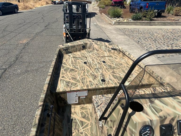 Camouflage aluminum boat with steering console and safety rail at ASFB Marine.