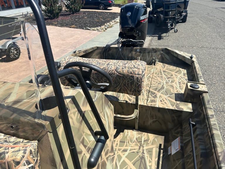 Interior view of Lowe RX 1860 jet boat with camouflage pattern and steering wheel.