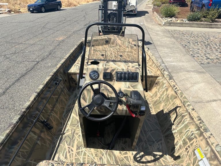 Aluminum Jon boat with 80HP jet motor and steering console.