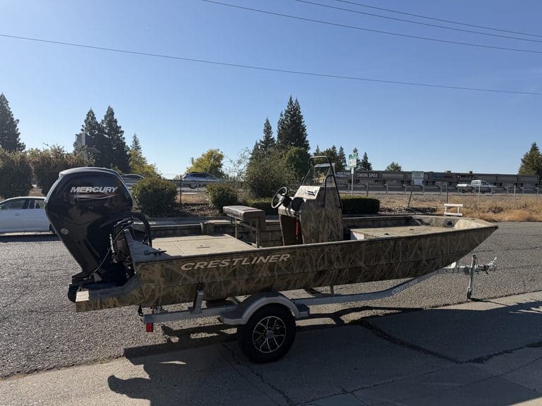 Crestliner 1860 Retriever CC boat with Mercury motor on trailer.