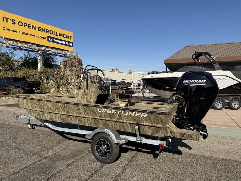 Crestliner 1860 Retriever CC fishing boat on trailer with Mercury engine.
