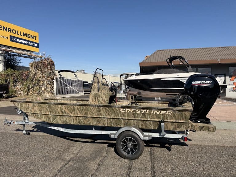 Crestliner 1860 Retriever CC fishing boat on trailer with Mercury engine.