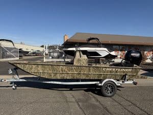 Crestliner 1860 Retriever CC fishing boat on trailer at dealership.