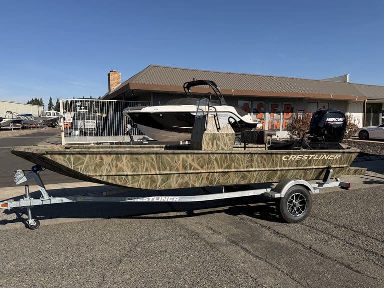 Crestliner 1860 Retriever CC fishing boat on trailer outside dealership.