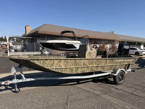 Crestliner 1860 Retriever CC boat on trailer outside dealership.