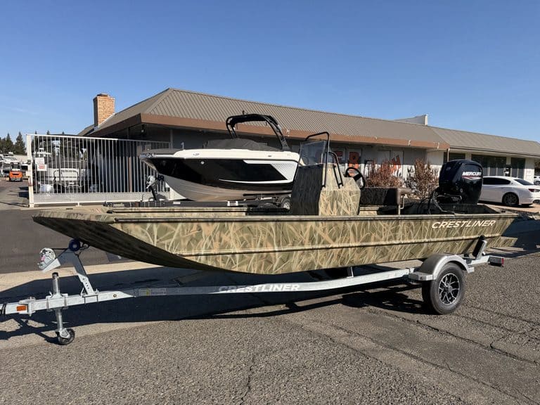 Crestliner 1860 Retriever CC boat on trailer outside dealership.