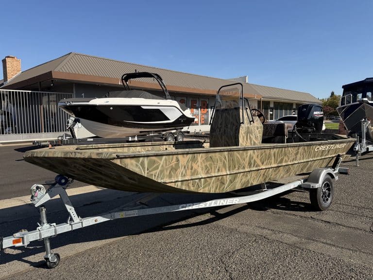 Crestliner 1860 Retriever CC fishing boat on trailer at dealership.