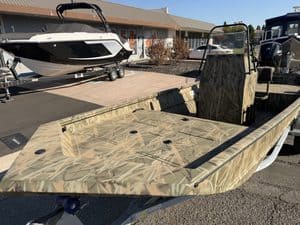 Crestliner 1860 Retriever CC fishing boat with camouflage pattern.