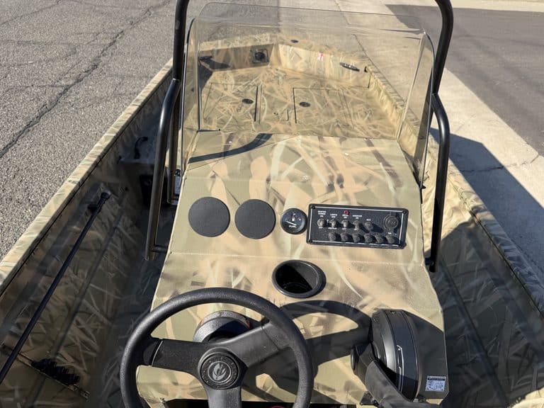 View of Crestliner 1860 Retriever CC boat dashboard and steering wheel.