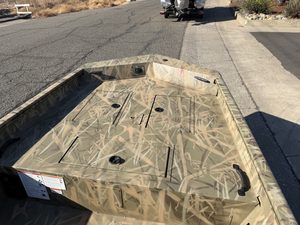 Crestliner 1860 Retriever CC fishing boat in camouflage pattern.