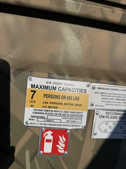 U.S. Coast Guard maximum capacity label on boat.