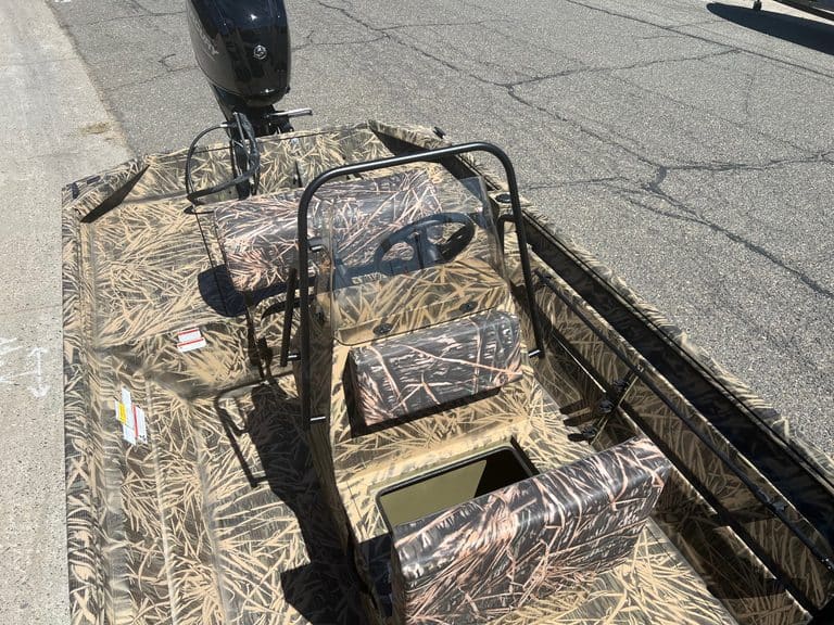 Camo-patterned Lowe RX 1860 jet boat with outboard motor and seating.