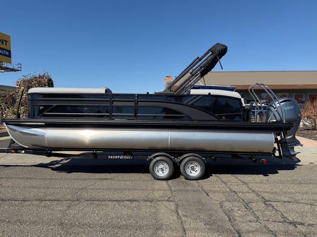 Pontoon boat with trolling motor on trailer at ASFB Marine.