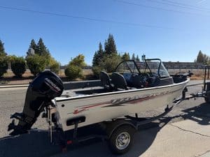 Tracker Pro boat with Mercury 60HP outboard engine on trailer.