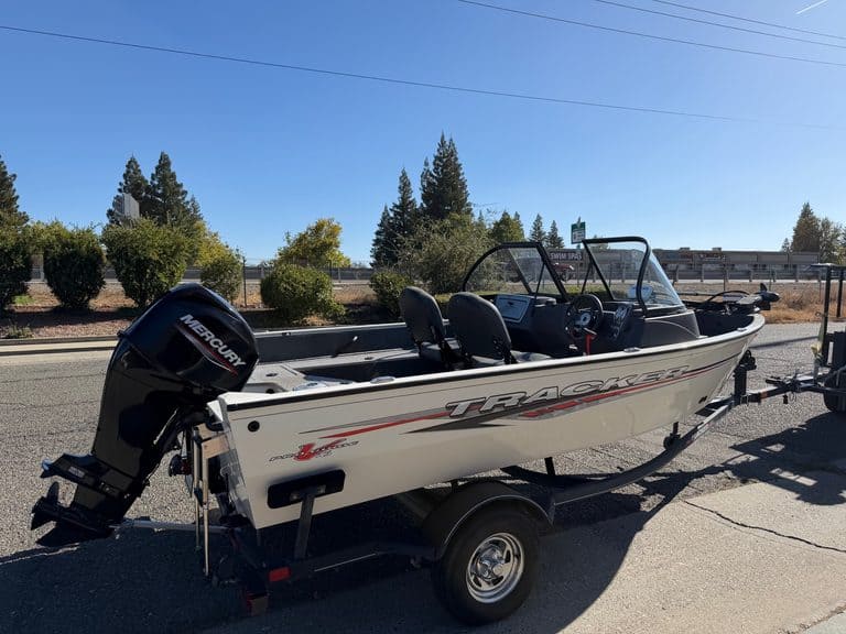 Tracker Pro boat with Mercury 60HP outboard engine on trailer.