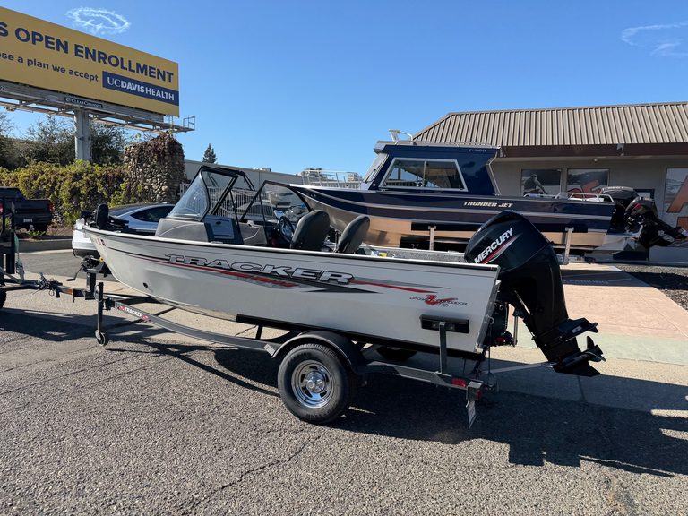 Tracker Pro boat with Mercury 60HP outboard motor on trailer.