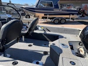 Fishing boat with Mercury 60HP engine and seating area.