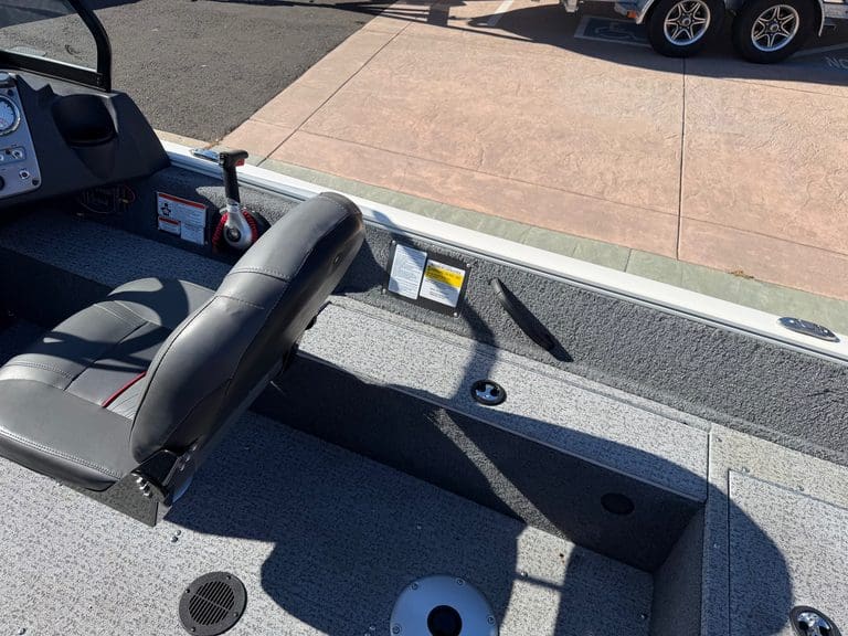 Close-up of boat interior with seat and storage compartments.