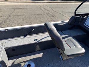 Boat interior with seat and storage for fishing or leisure.