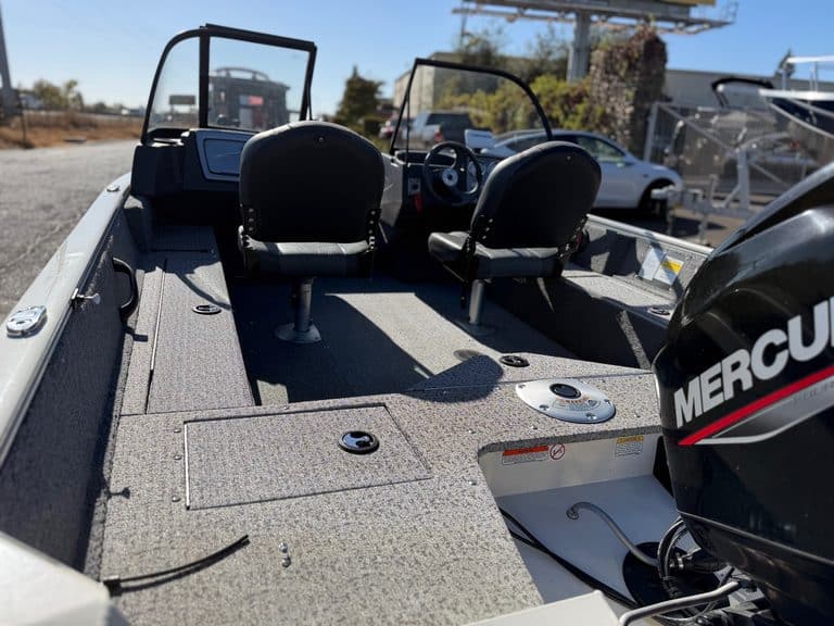 Boat interior with two seats and Mercury outboard engine.