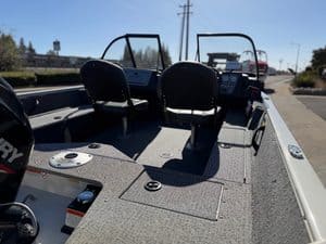 View of boat interior with seats and steering console at ASFB Marine.