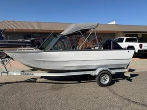 Aluminum boat with canopy on trailer at ASFB Marine dealership.