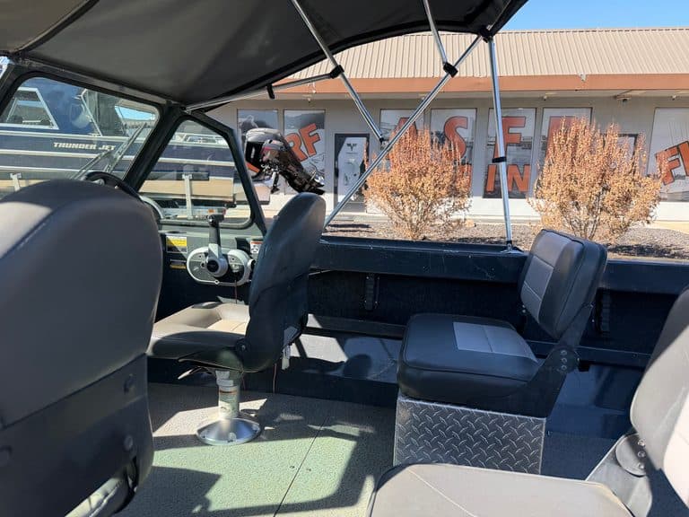 Interior view of a marine utility vehicle with seating and dashboard.