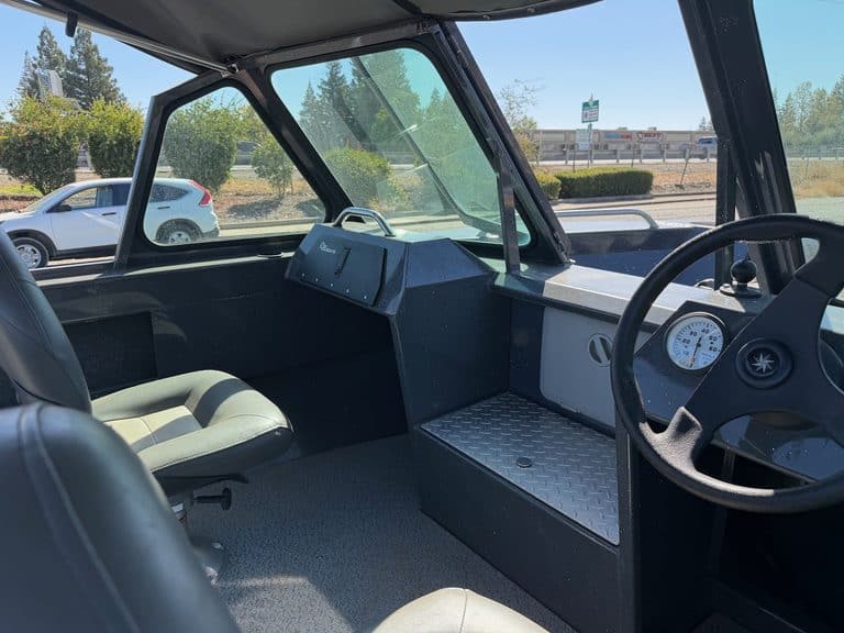 Interior view of an ASFB Marine utility vehicle with dashboard and seating.