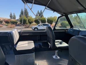 Interior view of a boat with seating and dashboard at ASFB Marine.