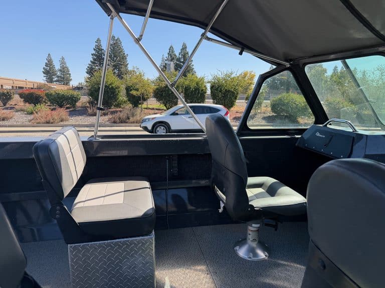 Interior view of a boat with seating and dashboard at ASFB Marine.