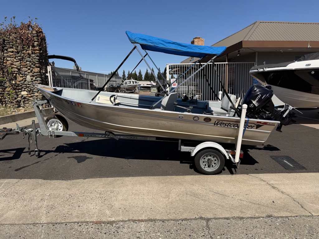 Aluminum boat with blue canopy on trailer at ASFB Marine.