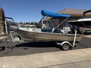 Westcoast Marine boat on trailer at ASFB Marine with blue canopy and outboard motor.