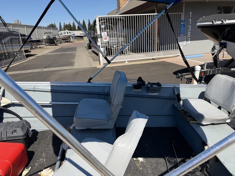 Aluminum fishing boat with seats and canopy at ASFB Marine.
