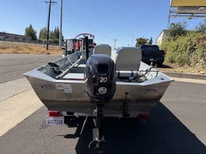 Klamath 15FT Advantage boat with outboard motor on trailer.