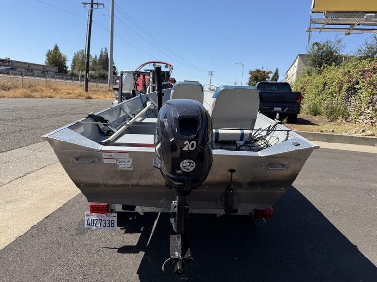 Klamath 15FT Advantage boat with outboard motor on trailer.