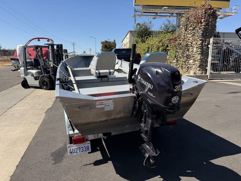 Klamath 15FT Advantage boat with outboard motor on trailer.