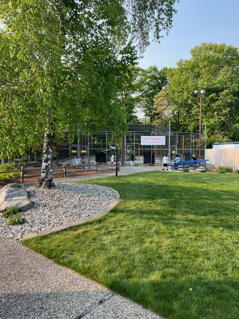 Outdoor sports facility with tennis courts and green park area.