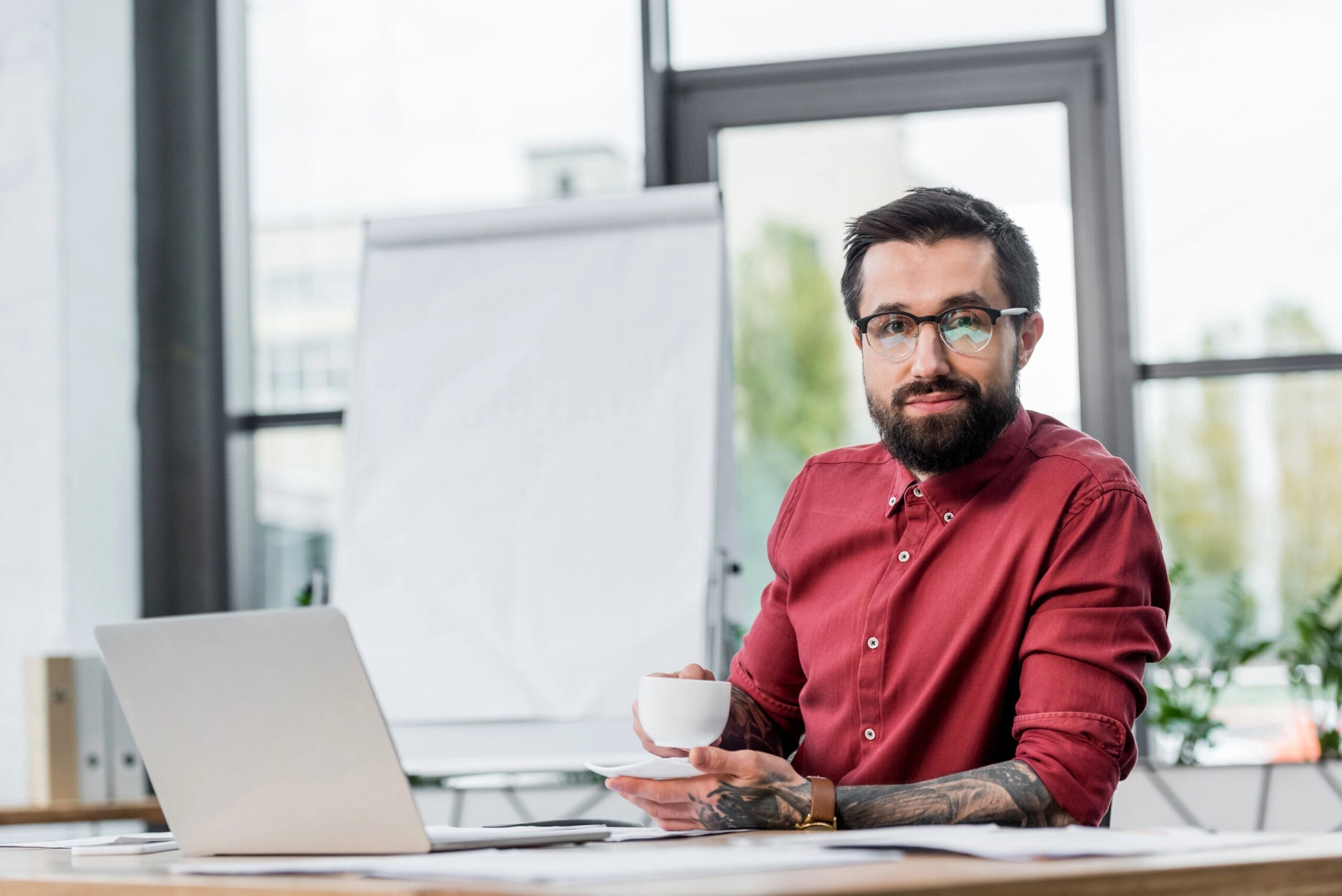 Man sat at desk in front of laptop