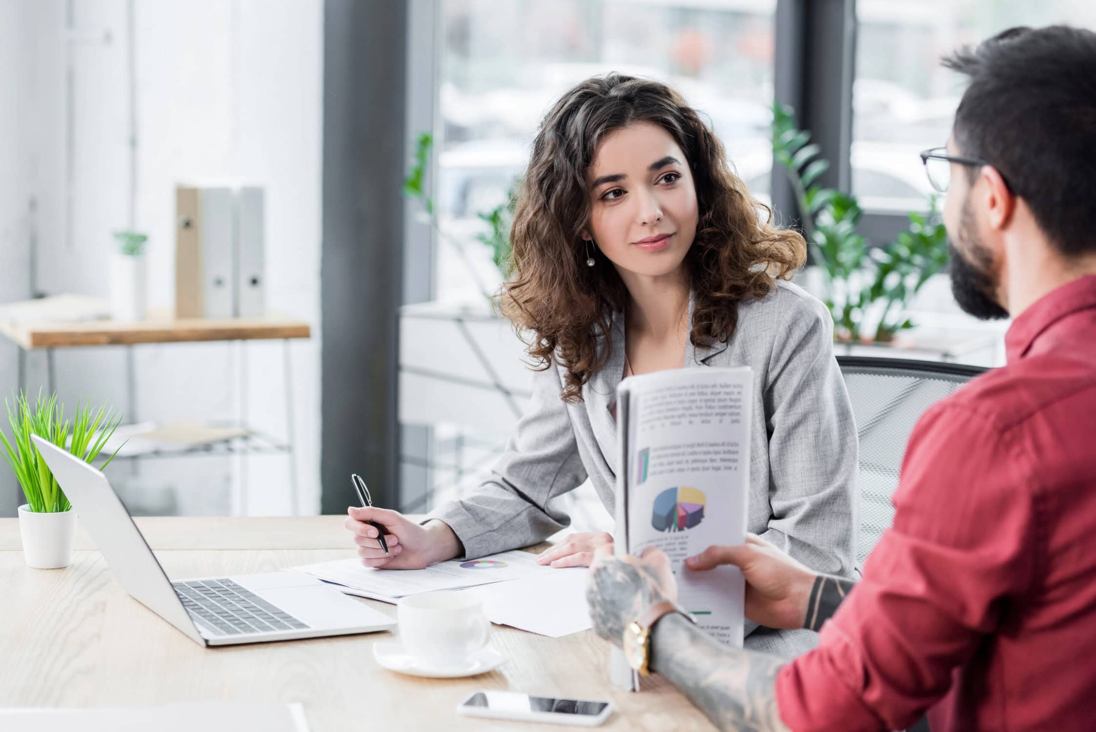 woman talks to man over reports