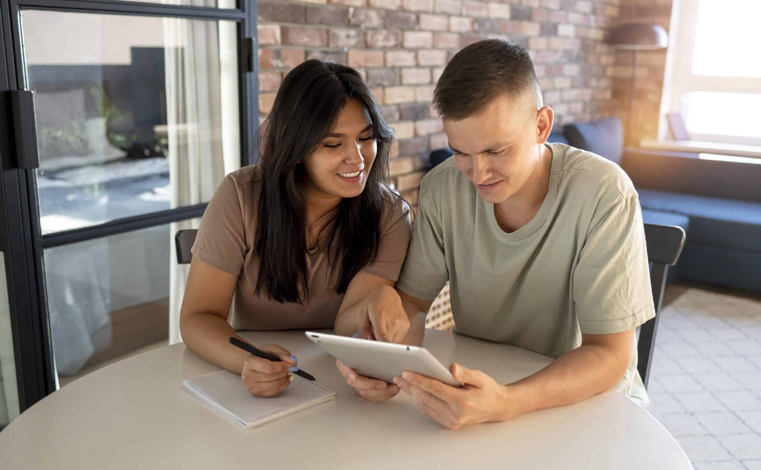 man woman making shopping list with tablet