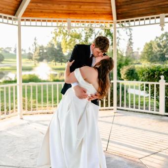 Elegant wedding couple kissing at Cascades Manor.