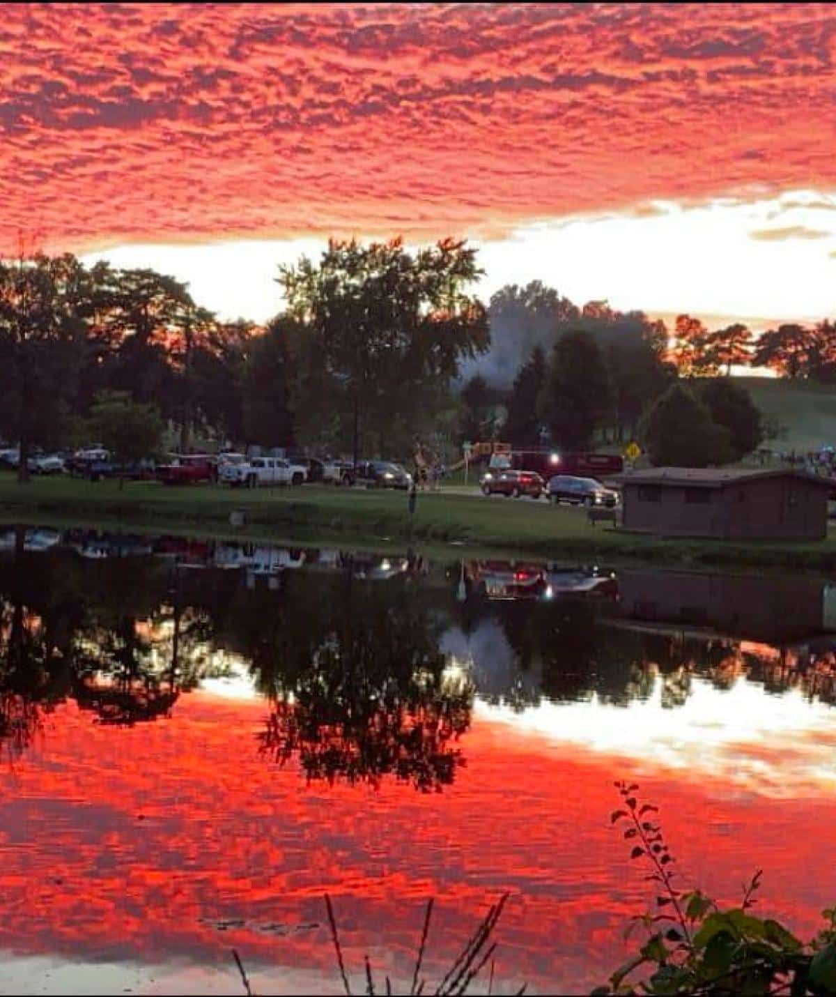 Beautiful sunset over Cascades Manor with vibrant red and orange sky reflection.