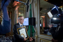 An award winner has an interview in front of a camera during the McKinsey Awards event in Brussels
