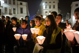 A group of people with candles in hand during 'For the Voiceless' manifestation event in Brussels