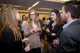 A group of people talking during an event to award Zabala as company of the year