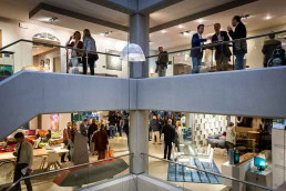 Building of Roche Bobois from inside showing guests during a night event in Brussels