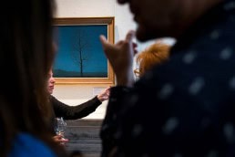 Visitors appreciating art during an art exhibition event by Sotheby's in Brussels