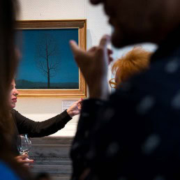Visitors appreciating art during an art exhibition event by Sotheby's in Brussels