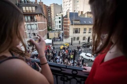Guests watch from a terrace during an art exhibition event by Sotheby's in Brussels