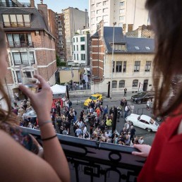 Guests watch from a terrace during an art exhibition event by Sotheby's in Brussels